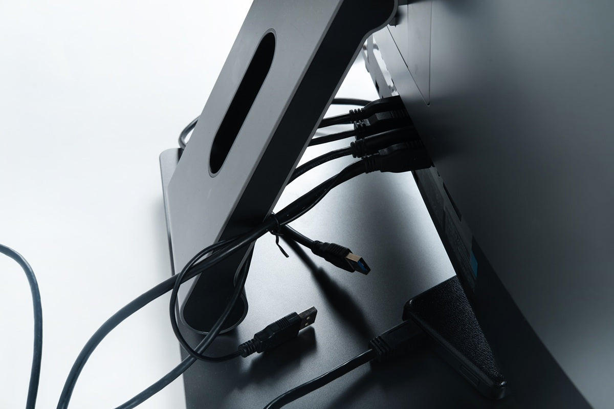 Monitor arm installation showing cable management, mounting clearance, and desk support considerations for a stable setup
