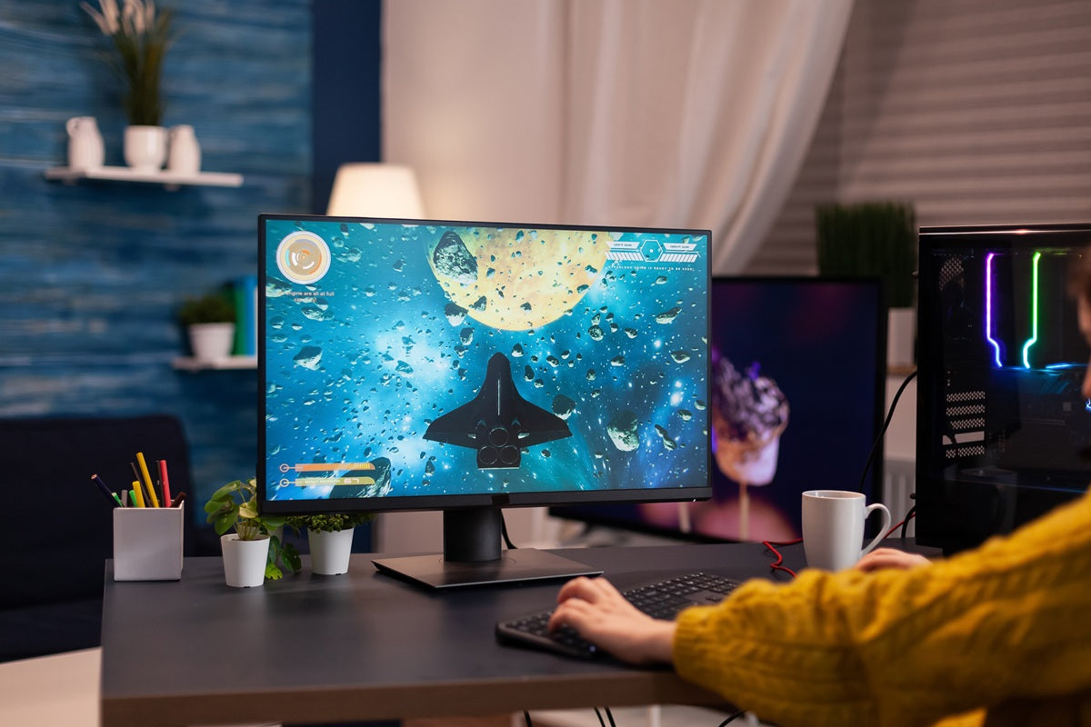 Monitor mount supporting a large ultrawide screen on a deep desk for ergonomic gaming and improved viewing comfort